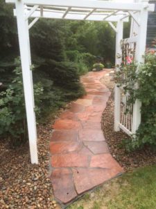 Red flagstone curved sidewalk in Boulder County, CO