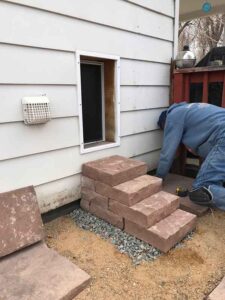 This custom dog entrance in Longmont, CO required an RS Custom Stone solution, which was a red flagstone dog staircase.