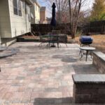 The Bogert paver patio includes circular entry step and a bench made with matching Bogert products.