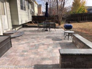 The Bogert paver patio includes circular entry step and a bench made with matching Bogert products.