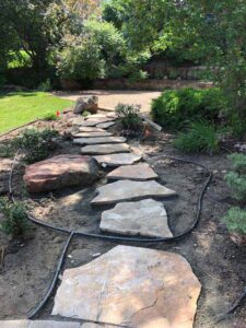 A traditional flagstone sidewalk completes the exterior Colorado Buff sandstone treatment for this Niwot, CO, home.