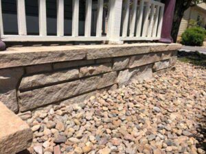 Locally sourced river rock landscaping blends in perfectly with the Colorado Buff overlay in this Niwot home.