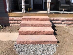 The solid red flagstone steps create a number of landscaping options for this Longmont homeowner.